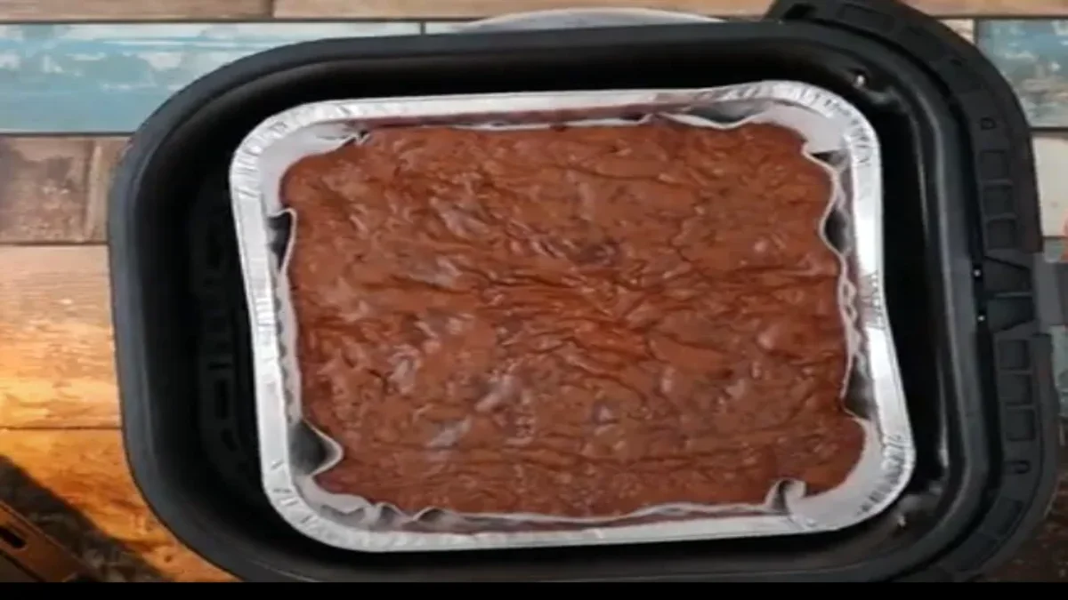 Fudgy air fryer brownies with a crackly top, cut into squares and served on a plate, perfect for a rich and easy dessert.