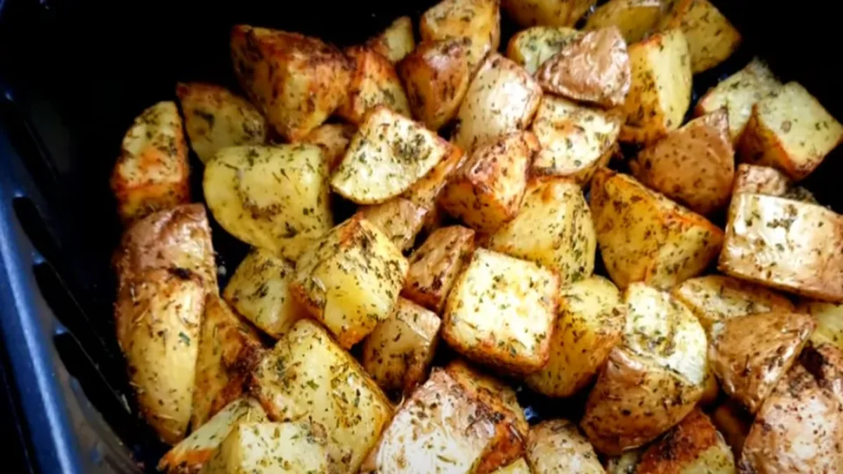 Crispy air fryer potatoes with golden edges, seasoned with herbs and spices, served hot as a side or snack.
