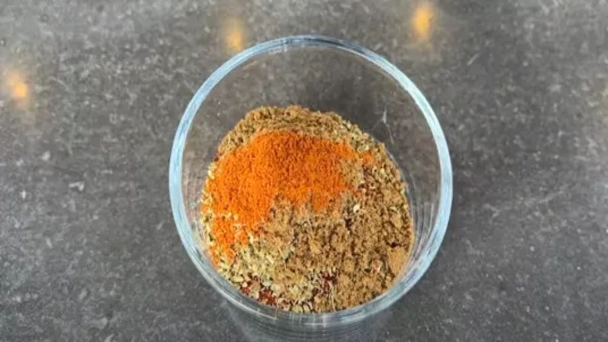 A variety of spices like paprika, salt, and garlic powder, laid out to create a homemade chicken rub