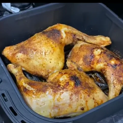 A perfectly cooked frozen chicken thigh air fryer, sliced and served on a plate